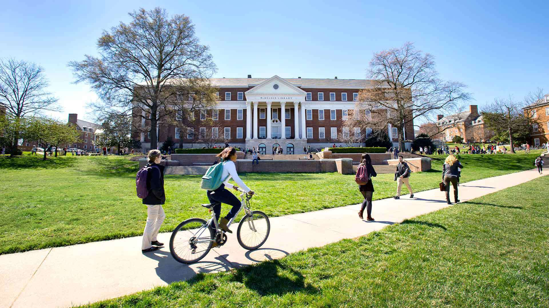 Students walking and biking across McKeldin Mall