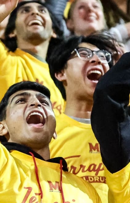 Student cheering at a sports game.