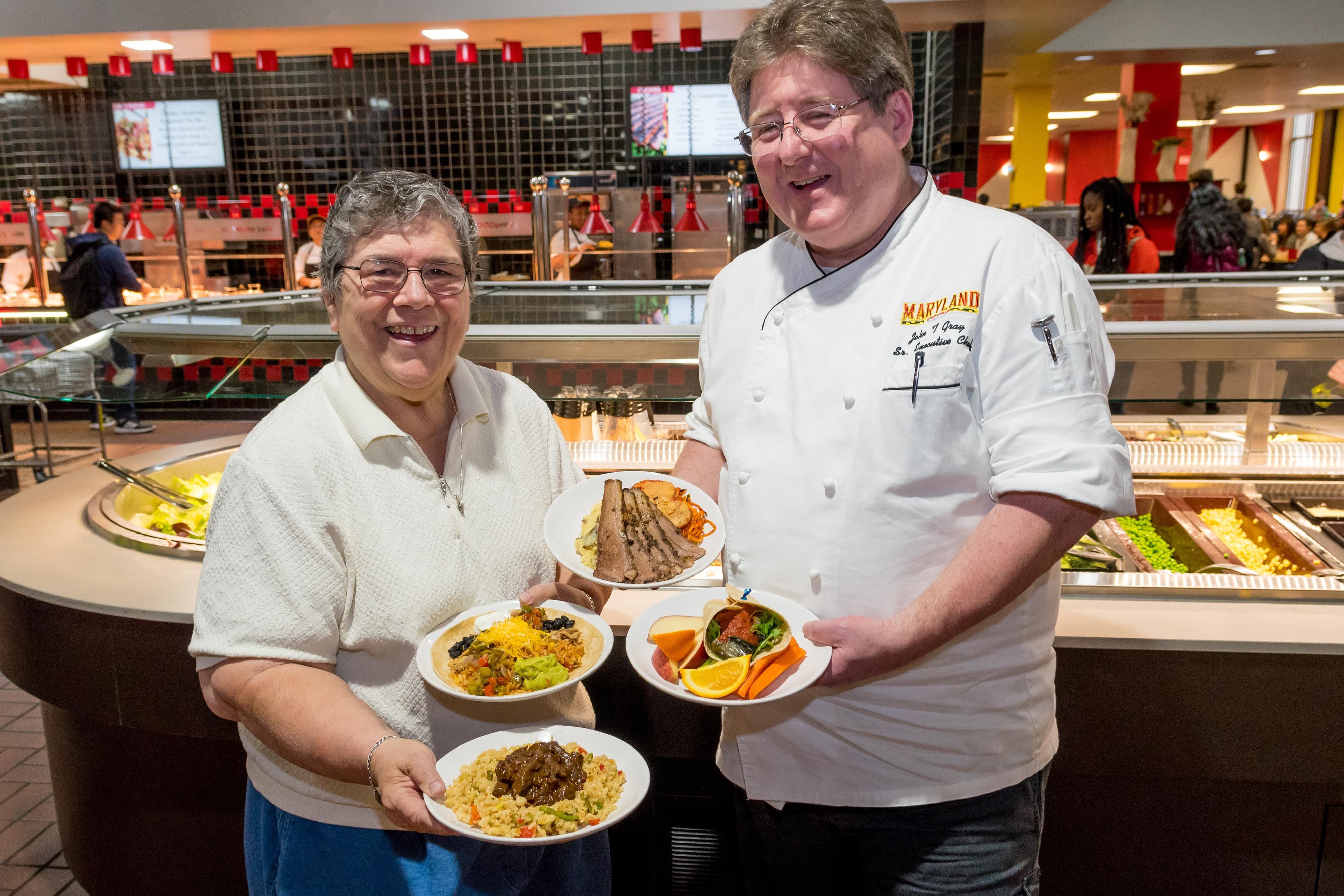 Chefs holding plates of food