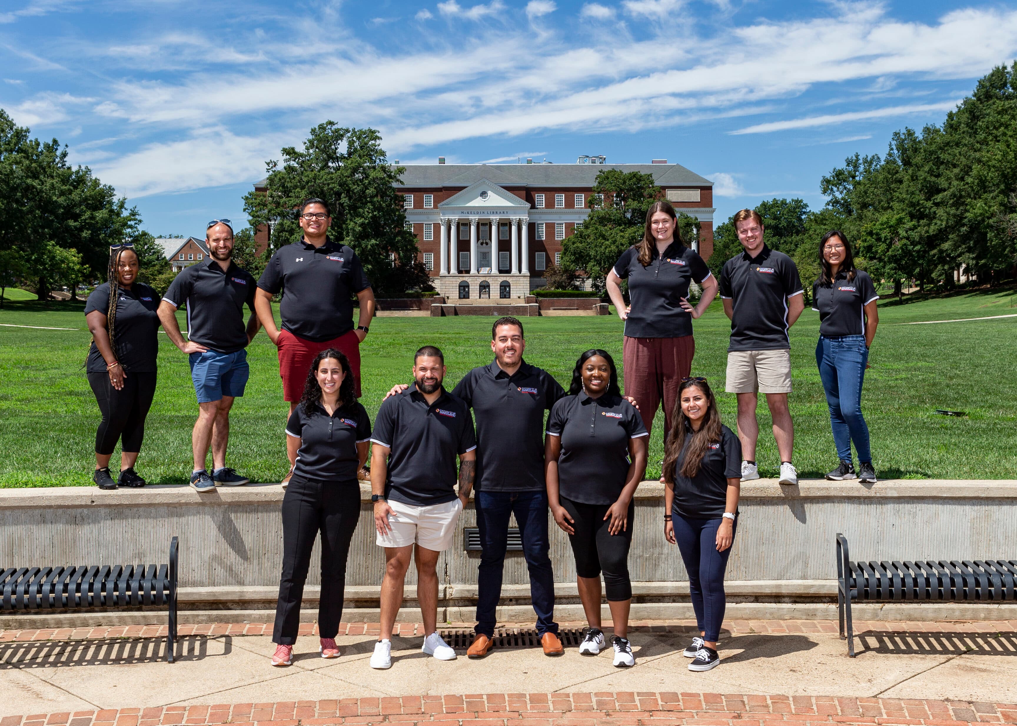 Office of Undergraduate Admissions staff standing together in front of McKeldin Mall.