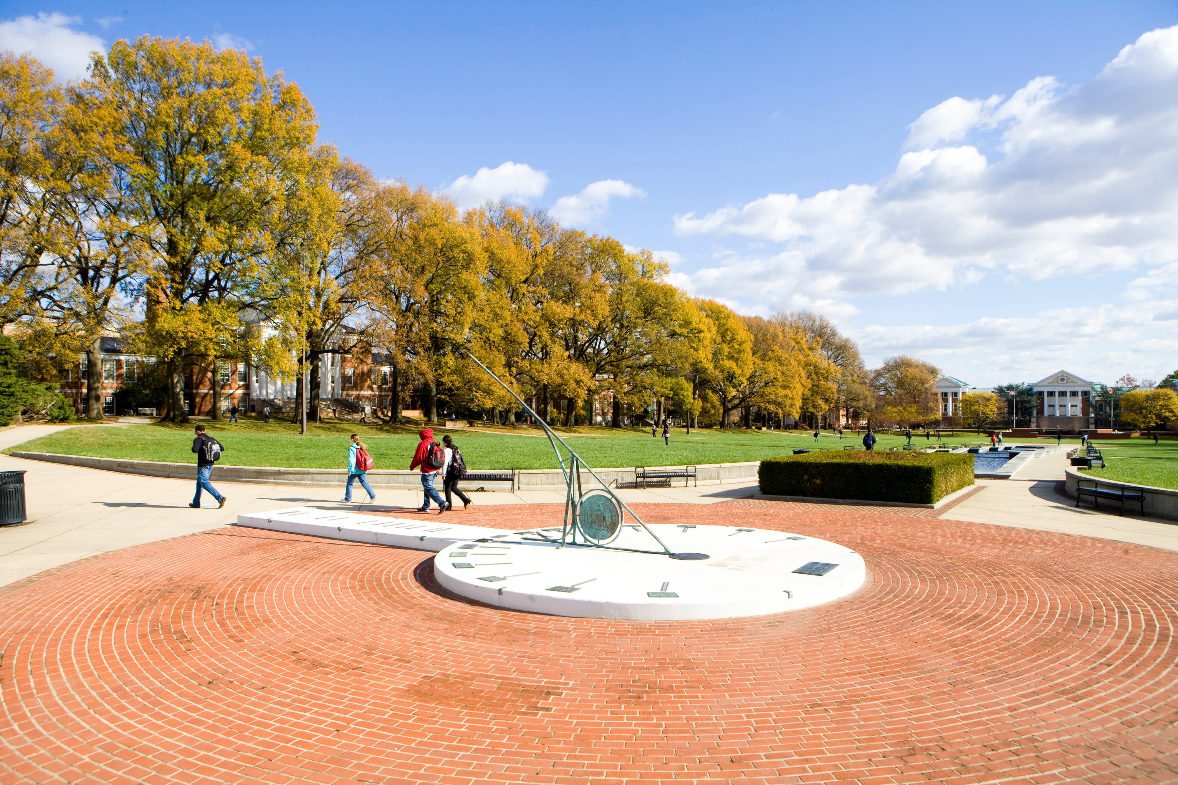 Sundial in McKeldin Mall with students walking past