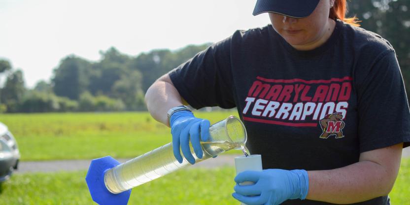 Person pouring water outside, testing